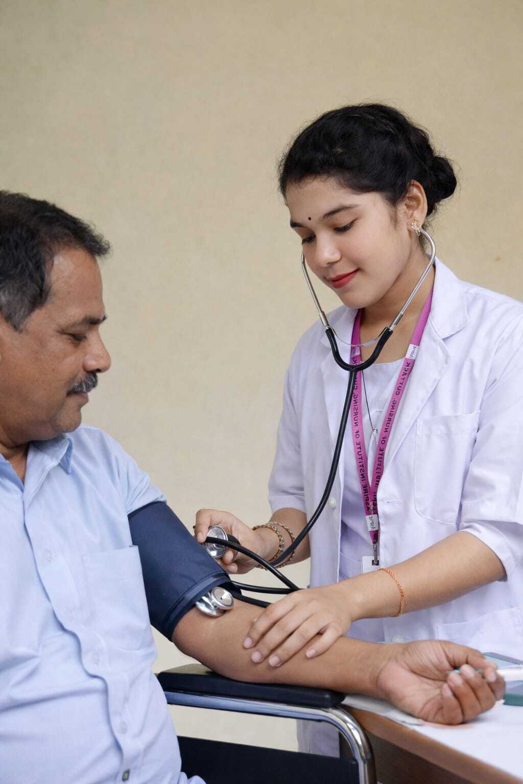 Professional caregiver assisting elderly patient